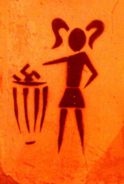 Stencil graffiti on an orange wall