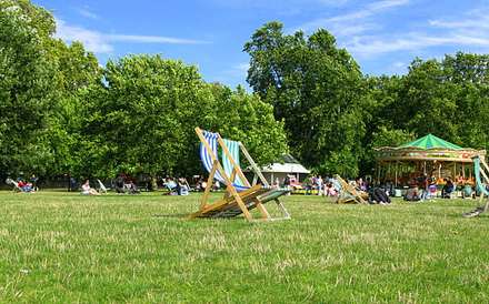 People on deckchairs in a large park