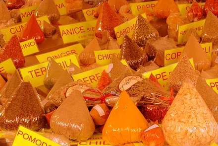 Pyramids of orange spices at the market