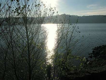 Lake and trees silhouetted at sunset